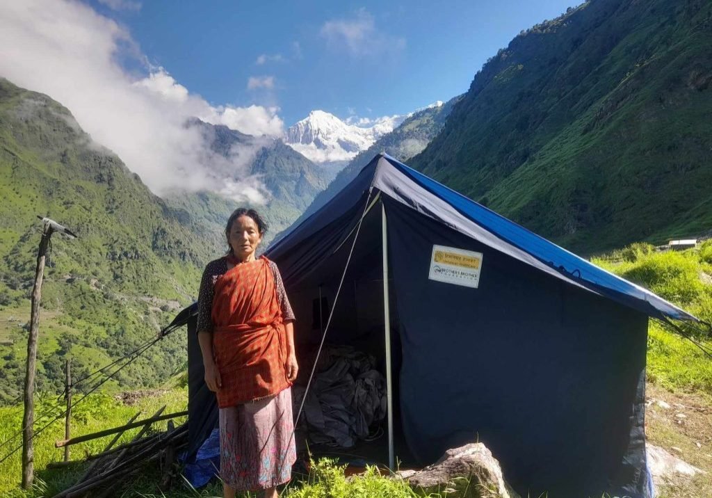 A woman in the Ruby Valley stands in front of a tent.
