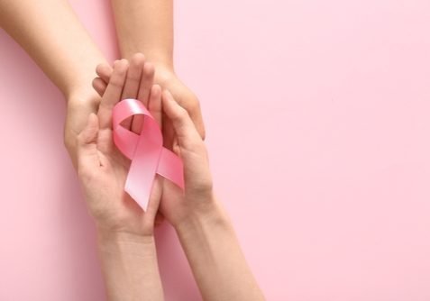 Women,Holding,Pink,Ribbon,On,Color,Background,,Closeup.,Breast,Cancer